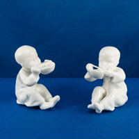 3073 China by royal worcetser showing a seated boy with chopsticks modelled by Freda Doughty as white unfinished unpainted figurines