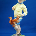 close up of red squirrel on boys leg, porcelain figure