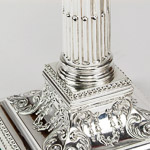 Silver corinthiam reeded and fluted fluted columns, beeded borders and hand-chased square bases with floral decoration