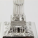 James Dixons candlesticks with embossed scrolling leaf and husk swag decoration amidst two bands of bead ornamentation
