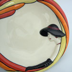 lady has black arm length gloves and hat with red lipstick and earrings