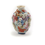 Moulded porcelain compressed oval form 19th century snuff bottle with a flat lip and recessed flat oval foot surrounded by a convex footrim