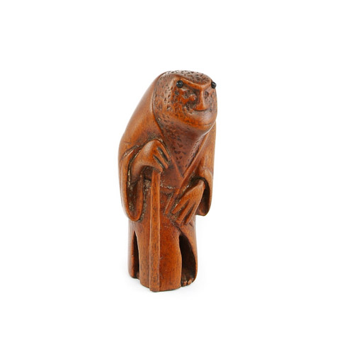 Antique Japanese Netsuke figure in form of toad or frog carved from tsuge boxwood with applied stain possibly yasha and eyes inlaid with carved black cow horn