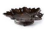 Dark wood musical fruit bowl sat on four feet with swiss cylinder comb music box