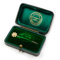 Antique gold tie stick pin with diamond chip and chester gold hallmark in green velvet presentation case by jeweller X.Ganz of 231 High Street, Swansea