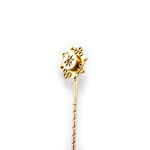 tie or cravat stick pin angled reflecting light on gold tie pin head